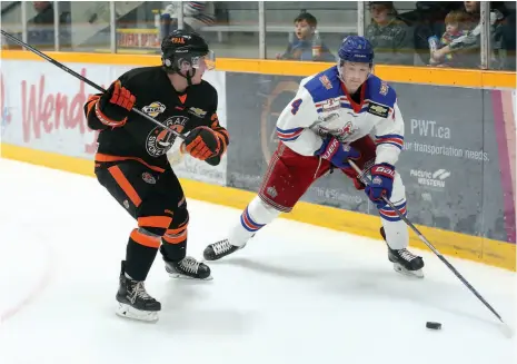  ?? CITIZEN PHOTO BY JAMES DOYLE ?? Prince George Spruce Kings defenceman Dylan Anhorn looks to make a play before absorbing a hit from Trail Smoke Eaters forward Owen Ozar on Wednesday night at Rolling Mix Concrete Arena.