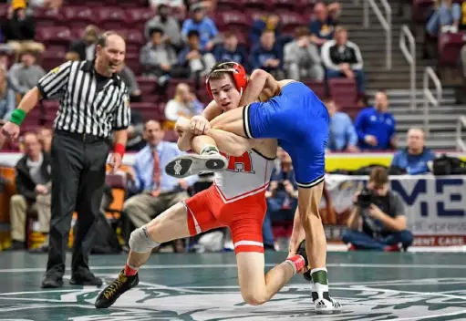  ?? Marc Billett/Tri-State Sports & News Service ?? North Hills senior Sam Hillegas attempts to take down Nazareth’s Dashawn Farber in the PIAA quarterfin­als Friday at Giant Center in Hershey, Pa. Hillegas, who won by a 12-2 major decision, is seeking his third PIAA title.