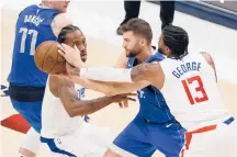  ?? MICHAEL AINSWORTH/AP ?? Clippers forward Kawhi Leonard, left, and guard Paul George (13) pressure Mavs center Dwight Powell during Game 6 on Friday in Dallas.