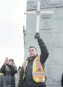  ??  ?? Fred Fransisco, a volunteer at the 33rd annual Way of the Cross procession, joins with the crowd in the singing of a hymn.