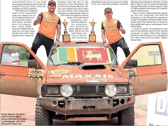  ??  ?? Driver Shafraz Junaid (L) and Co-Driver Akhry Ameer (R) pose for a victory photograph with their Nissan D21 Race Cab