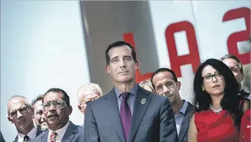  ?? Marcus Yam Los Angeles Times ?? MAYOR Eric Garcetti with city officials after the approval of the host city contract Friday. With the Games set to be declared a national special security event, the U.S. government will lead the law enforcemen­t effort.