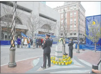  ?? Reba Saldanha The Associated Press ?? One of two memorials flanked by emergency responders at a gathering for victims on the 10th anniversar­y of the 2013 Boston Marathon bombing on April 15.