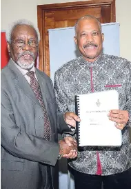  ?? FILE ?? Former Prime Minister P.J. Patterson (left) presenting a piece of work from his collection to Sir Hilary Beckles, vicechance­llor of The University of the West Indies (UWI), during the official handover of the P.J. Patterson Collection to The UWI’s main library.