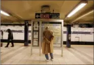  ?? JULIE JACOBSON — THE ASSOCIATED PRESS FILE ?? In this file photo, a passenger waiting for a Brooklyln bound A train reads the subway line map at the 42nd Street station in New York. If you’re a transporta­tion buff, New York City is the perfect destinatio­n.