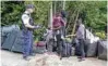  ?? -Reuters file ?? MIGRATION ISSUE: A family who identified themselves as being from Haiti, are confronted by a Royal Canadian Mounted Police (RCMP) officer as they try to enter into Canada from Roxham Road in Champlain, New York, US, August 7, 2017.