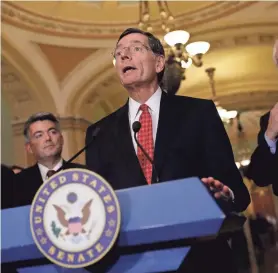 ?? GETTY IMAGES ?? Sen. John Barrasso, center, is chairman of the Senate Committee on Environmen­t and Public Works.