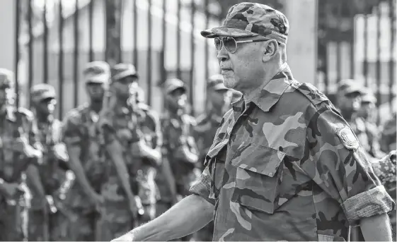  ?? REUTERS ?? Suriname’s President Dési Bouterse reviews the troops during a ceremony at the Memre Buku military barracks, in Paramaribo, Suriname, in March 2019. This week Bouterse lost the election and may be headed to jail on a previous murder conviction.