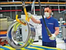  ?? MASSIMO PINCA / REUTERS ?? A worker is seen on Monday at a factory that produces metal bearings for cars, buses and planes in San Benigno Canavese, Italy, as the country gets back to work after a nationwide lockdown to slow the spread of COVID-19.