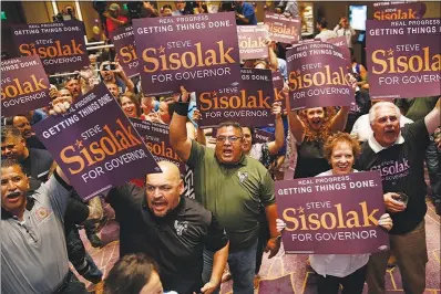  ?? JOHN LOCHER / AP ?? Supporters of Clark County Commission Chairman and Democratic gubernator­ial candidate Steve Sisolak cheer Tuesday at an election night party in Las Vegas. Sisolak endured a bruising Democratic primary challenge from fellow County Commission­er Chris...