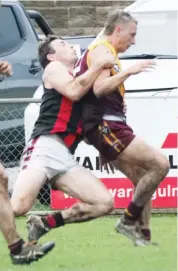  ??  ?? Drouin’s Jackson Kos is dispossess­ed of the ball by a strong tackle by Sam Walker in the senior game against Maffra.