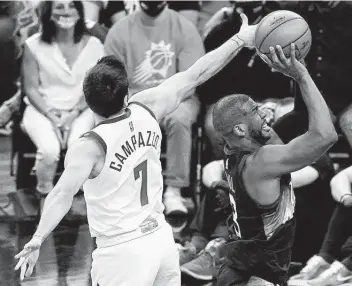  ?? Matt York / Associated Press ?? Suns star Chris Paul, right, had everything working Wednesday night, scoring 17 points to go with 15 assists and leaving Facundo Campazzo and the Nuggets in search of answers after a 123-98 beatdown in Game 2.