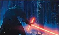  ?? DISNEY/THE ASSOCIATED PRESS ?? Adam Driver as Kylo Ren wields his lightsaber in “Star Wars: The Force Awakens.” The movie has set many box-office records.