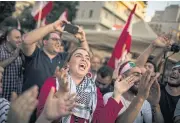  ?? NYT ?? Anti-government protesters in Beirut celebrate after Prime Minister Saad Hariri announced his resignatio­n.