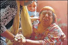  ?? AP ?? Mother of sarpanch Ajay Pandita Bharti in an inconsolab­le state on Tuesday.