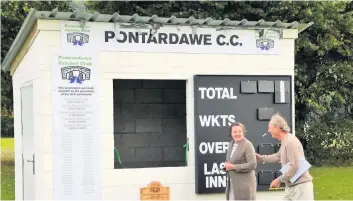  ??  ?? Treasurer Ann Williams and Pontardawe CC chairman Rob Pick after Ann had cut the ribbon to open the club’s new scorebox.