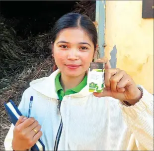  ?? HONG RAKSMEY ?? Hak Chamroeun, project manager of Sambo Meanchey Agricultur­al Cooperativ­e, shows off a sample from the co-op’s product line on December 7.