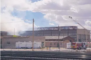  ?? ADOLPHE PIERRE-LOUIS/ JOURNAL ?? Firefighte­rs battle a fire at the Albuquerqu­e Rail Yards south of Downtown Monday afternoon. The fire ignited in a vacant building and affected three structures before it was contained.