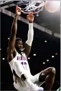  ?? AP PHOTO BY RICK SCUTERI ?? Arizona forward Deandre Ayton dunks against North Dakota State in the second half during an NCAA college basketball game, Monday in Tucson, Ariz.