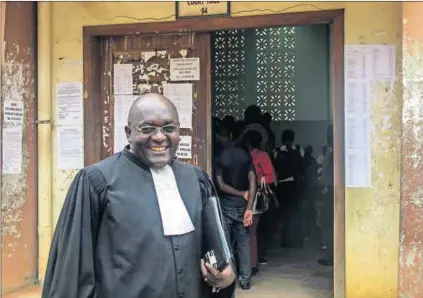  ?? Photos: Reinnier Kaze and Isaac Kasamani/AFP ?? Standing up: Cameroonia­n lawyer Michel Tougé had to move his family, who were being threatened, to the US. A Ugandan at the 2014 annual gay pride in Entebbe (below).