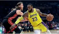  ?? AP ?? Lakers’ LeBron James (23) dribbles next to Miami Heat’s Kelly Olynyk during their match on Monday. —