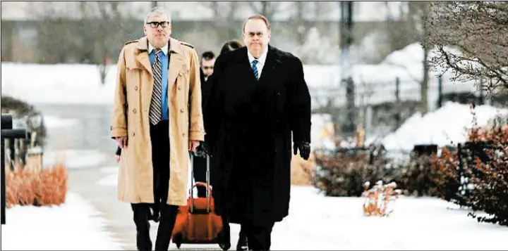  ?? SUZANNE TENNANT/POST-TRIBUNE ?? Ex-Lake County Sheriff John Buncich, right, walks to the federal courthouse in Hammond with his attorney, Bryan Truitt, for his sentencing in January 2018.