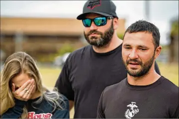  ?? PHOTOS BY ALLEN EYESTONE / THE PALM BEACH POST ?? Nik Kayler’s sister-in-law Casey and brother Phil listen Wednesday at the Roland Martin Marina in Clewiston as halfbrothe­r Anthony Llanos thanks everybody who helped in the search.