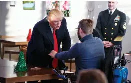  ?? — AP ?? US President Donald Trump meets retired US Marine Corps Sgt. John Peck and his wife Jessica as the President visits wounded service members and their families during a visit to Walter Reed National Military Medical Centre in Bethesda, Maryland, on...