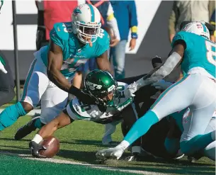  ?? SETH WENIG/AP ?? Jets running back Breece Hall reaches the ball across the goal line for a touchdown against the Dolphins in the fourth quarter on Sunday in East Rutherford, N.J.