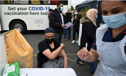  ??  ?? A member of the public receives a Covid-19 vaccine at a vaccinatio­n centre in Bolton on Friday. Photograph: Oli Scarff/AFP/Getty