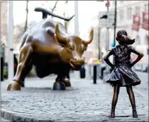  ?? ASSOCIATED PRESS ?? THE CHARGING BULL AND FEARLESS GIRL statues sit on Lower Broadway in New York in this March 22 photo. The installati­on of the bold girl defiantly standing in the bull’s path has transforme­d the meaning of one of New York’s best-known public artworks.