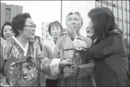  ?? LIU DAN / CHINA NEWS SERVICE ?? People pose in front of the “comfort women” statue at St. Mary Square in San Francisco on Sept 22, 2017.