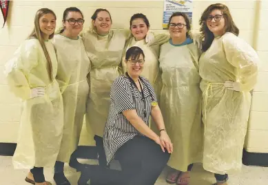  ?? COURTESY PHOTO ?? High school students who joined the first nurse aide training though RappU stand in the school hall after a practice session putting on personal protective wear. From left to right: Jacklyn Humphries, Courtney Higgins, Karley Wharton, Shadow Jenkins,...