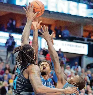  ?? [AP PHOTO] ?? Thunder forward Paul George, center, puts up a shot against the Mavericks’ DeAndre Jordan, left, Dorian Finney-Smith in the first half of OKC’s 111-96 loss at Dallas.