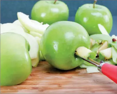  ?? TRIBUNE CONTENT AGENCY ?? Core and peel the apples before making the pies.