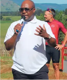  ?? ?? Sydney Mbhele, Absa’s group chief brand, marketing and corporate affairs officer, addresses the staff, pupils and cyclists at the handover of the new library.