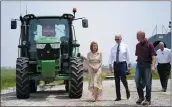  ?? ANDREW HARNIK — THE ASSOCIATED PRESS ?? President Joe Biden walks with O’Connor Farms owners Jeff O’Connor and Gina O’Connor, left, at the farm Wednesday in Kankakee, Ill.