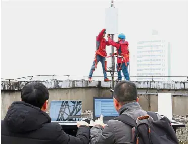  ?? — Reuters ?? Risky situation: China Unicom technician­s test the equipment at a newly-built 5G network base station in Tongling, Anhui province. Analysts warn that growing enthusiasm for anything with a link to 5G risks spiralling out of control.
