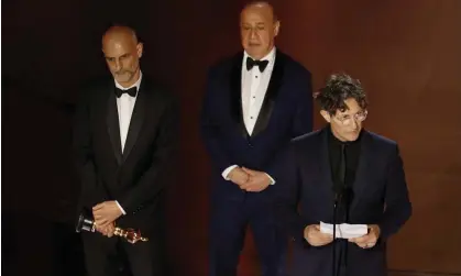  ?? Photograph: Caroline Brehman/EPA ?? Controvers­y … (left to right) producers James Wilson, Leonard Blavatnik and director Jonathan Glazer collect the Oscar for best internatio­nal film for The Zone of Interest.