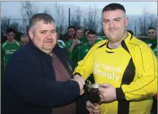  ??  ?? Philip O’Brien of the Wexford Football League presents the cup to Kiltealy Celtic captain Ben Nugent.