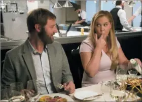  ?? MARK SCHAFER — STX VIA AP ?? Rory Scovel, left, and Amy Schumer in a scene from “I Feel Pretty.”