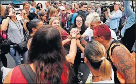  ?? [GERALD HERBERT/THE ASSOCIATED PRESS] ?? Students who survived the shooting at Marjory Stoneman Douglas High School, along with survivors of the Pulse nightclub shooting in Orlando, unite Tuesday before the students board a bus in Parkland, Fla., on their way to the state Capitol in...