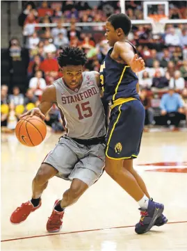  ?? JIM GENSHEIMER/STAFF ?? Stanford guard Marcus Allen, left, drives past Cal’s Charlie Moore.