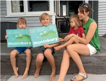  ??  ?? Huntsbury residents Anna Siggs-Webster and her three children, from left, Jake, Ben and Bo, advertise the Huntsbury 100 celebratio­ns next weekend.