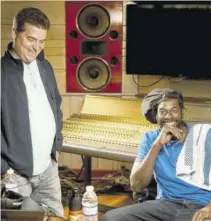  ??  ?? William Mahfood (left), chairman of Wisynco Group, lymes with Buju Banton at his Kingston studio recently.