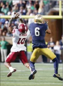  ?? CHARLES REX ARBOGAST — THE ASSOCIATED PRESS ?? Temple defensive back Mike Jones (10) intercepts a pass intended for Notre Dame’s Equanimeou­s St. Brown during the second half Saturday in South Bend, Ind. Notre Dame won, 49-16.