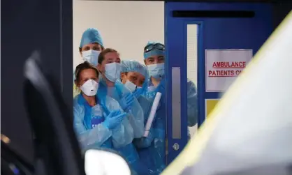  ??  ?? NHS workers at Aintree University hospital during a clap for carers applause. Photograph: Phil Noble/Reuters