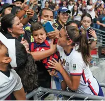  ?? FERNANDO LLANO/ASSOCIATED PRESS ?? The United States’ Alex Morgan holds a child Thurday as she greets fans after defeating Jamaica 5-0 in a CONCACAF Women’s Championsh­ip soccer match in Monterrey, Mexico.