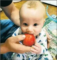 ?? Chesley Schaefer photo ?? Baby Arthur’s first taste of a peach, back in June. He’s a pro eater now, but still needs milk.