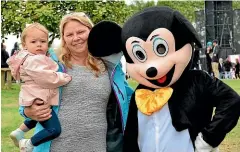  ??  ?? Lily Shord and Erin Mooney from Brisbane meet Mickey Mouse.